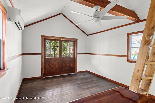 entrance foyer featuring a wall unit AC, a wealth of natural light, dark wood-type flooring, and vaulted ceiling