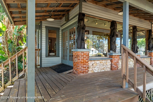 wooden terrace featuring ceiling fan and french doors