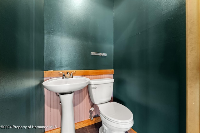 bathroom featuring tile patterned flooring, toilet, and sink