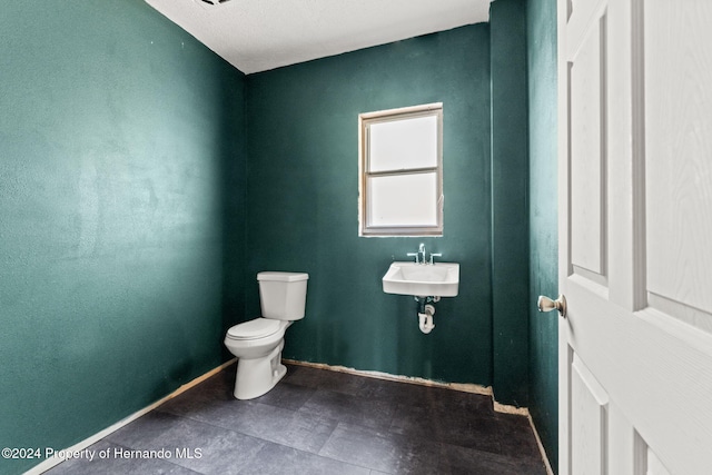 bathroom featuring sink and toilet