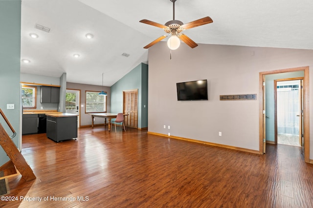 unfurnished living room with dark hardwood / wood-style flooring, high vaulted ceiling, and ceiling fan