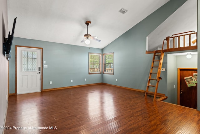 unfurnished living room with dark hardwood / wood-style floors, plenty of natural light, lofted ceiling, and ceiling fan