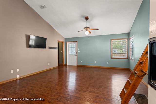 unfurnished living room featuring plenty of natural light, ceiling fan, dark hardwood / wood-style flooring, and lofted ceiling