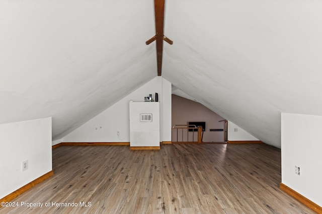 additional living space featuring hardwood / wood-style flooring and lofted ceiling