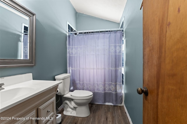 full bathroom with vanity, vaulted ceiling, hardwood / wood-style flooring, toilet, and shower / bathtub combination with curtain