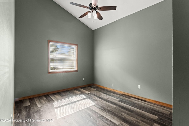 empty room with dark hardwood / wood-style flooring, ceiling fan, and lofted ceiling