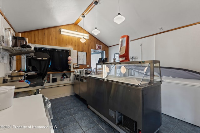 kitchen with vaulted ceiling, hanging light fixtures, and wooden walls