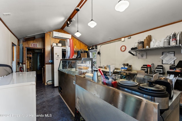 kitchen with a wall mounted air conditioner, vaulted ceiling, crown molding, decorative light fixtures, and wood walls