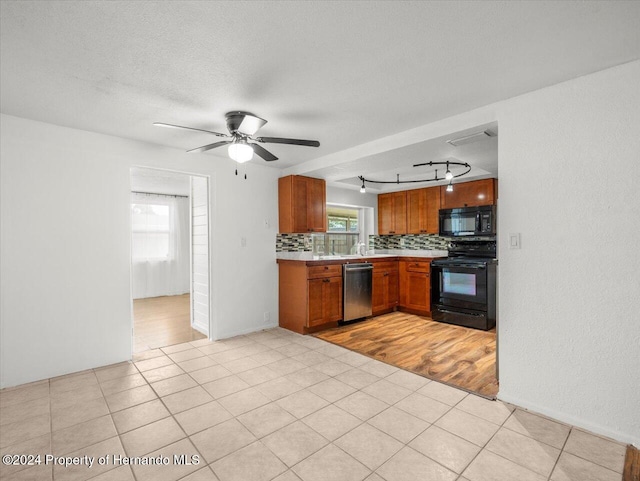 kitchen with black appliances, tasteful backsplash, light wood-type flooring, track lighting, and ceiling fan