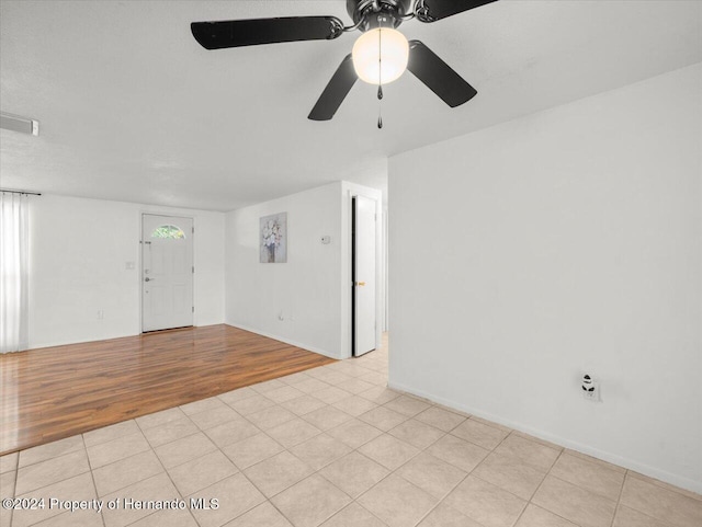 spare room featuring ceiling fan and light hardwood / wood-style floors