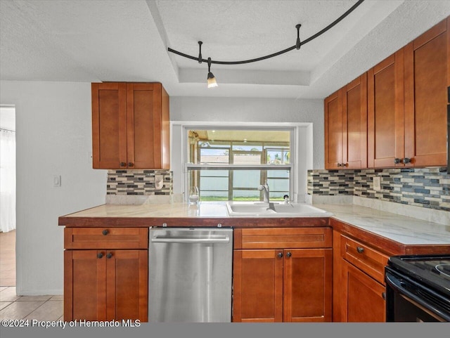 kitchen featuring stainless steel dishwasher, a textured ceiling, sink, and tasteful backsplash