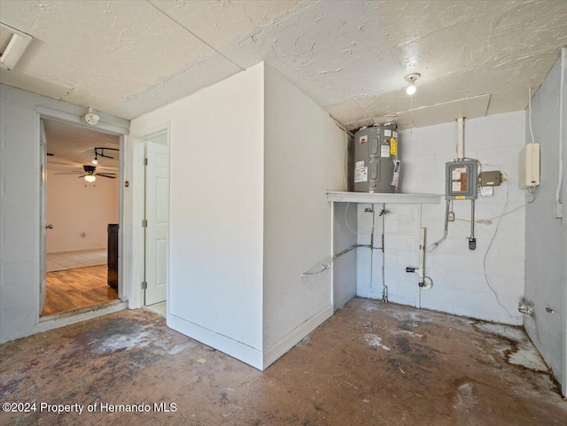 basement featuring ceiling fan and water heater