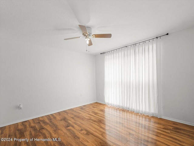 unfurnished room featuring hardwood / wood-style flooring and ceiling fan