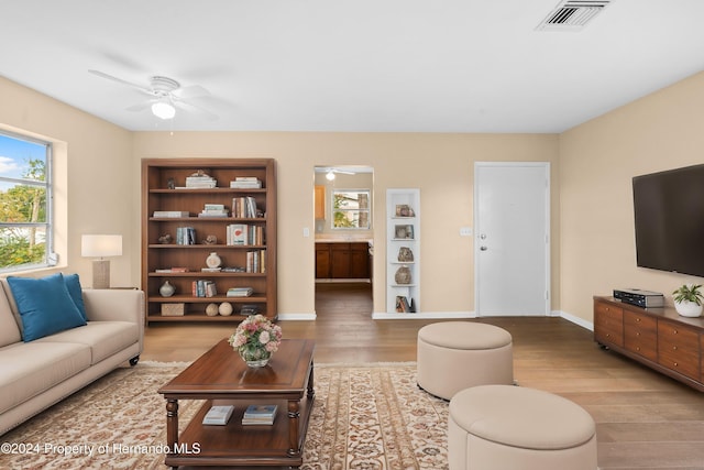 living room featuring wood-type flooring and ceiling fan