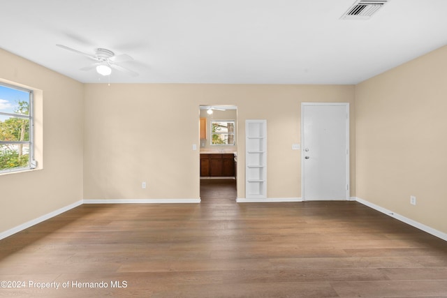 unfurnished room with wood-type flooring and ceiling fan