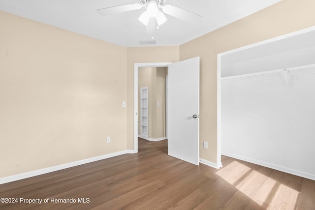 unfurnished bedroom with hardwood / wood-style flooring, ceiling fan, and a closet