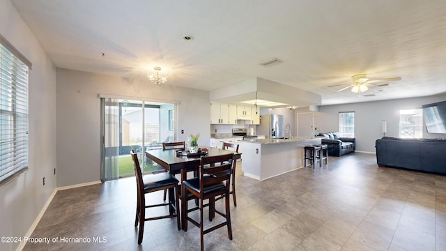 dining room with ceiling fan and sink