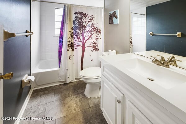 full bathroom featuring toilet, shower / tub combo, and vanity