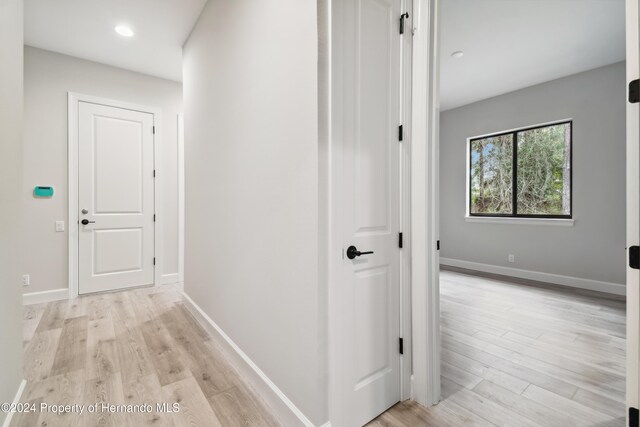 19411 Sheltered Hill Dr, Brooksville, FL 34601 - corridor with light wood finished floors, baseboards, and recessed lighting