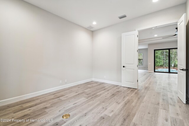 19411 Sheltered Hill Dr, Brooksville, FL 34601 - empty room featuring light wood-style floors, recessed lighting, and baseboards