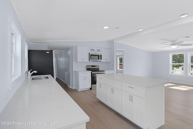 kitchen featuring white cabinets, sink, light hardwood / wood-style flooring, a kitchen island, and stainless steel appliances