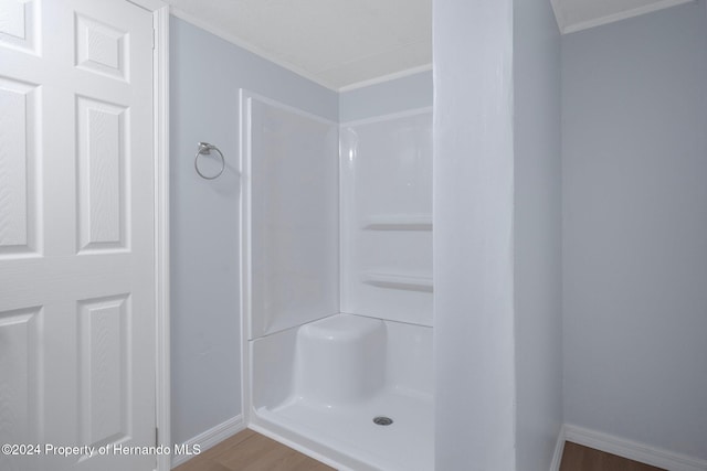 bathroom with a shower and hardwood / wood-style flooring