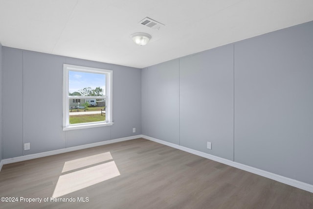 spare room featuring light hardwood / wood-style flooring