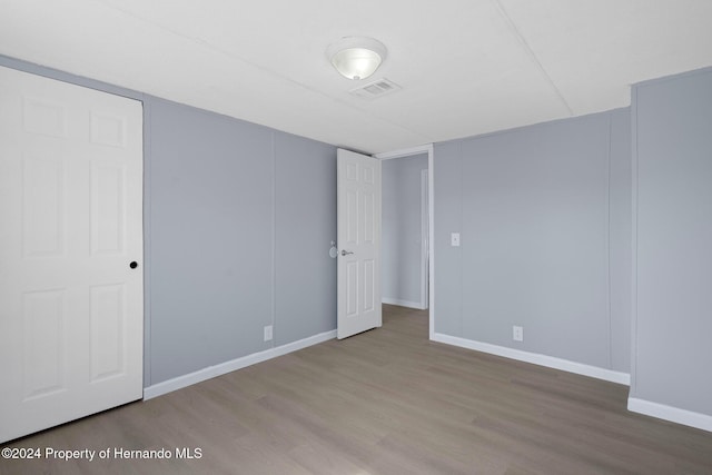 empty room with hardwood / wood-style floors