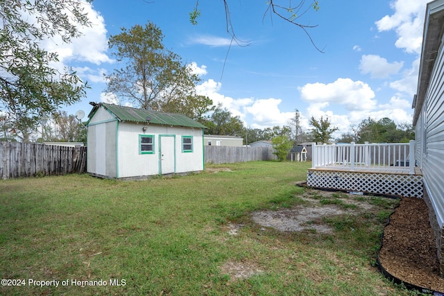 view of yard with a deck and a storage shed