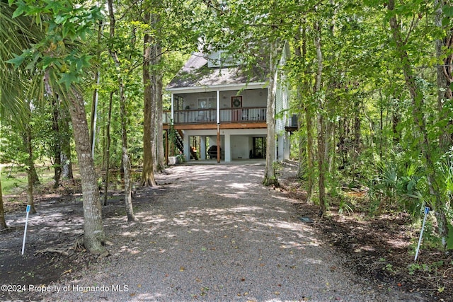 7413 Gettysburg Dr, Weeki Wachee, FL 34607 - raised beach house with a carport and dirt driveway