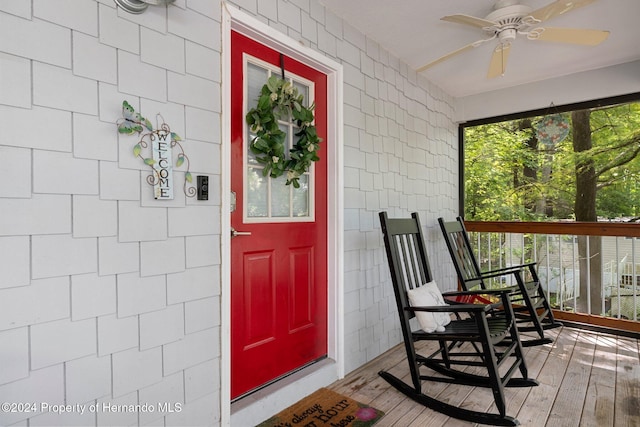 property entrance featuring covered porch and ceiling fan