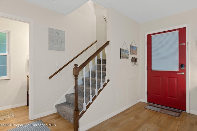 7413 Gettysburg Dr, Weeki Wachee, FL 34607 - entrance foyer with wood finished floors, stairs, and baseboards