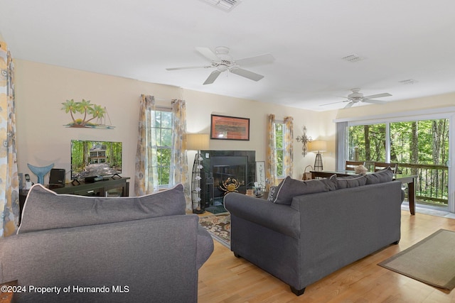 7413 Gettysburg Dr, Weeki Wachee, FL 34607 - living area featuring plenty of natural light, a ceiling fan, and light wood-type flooring
