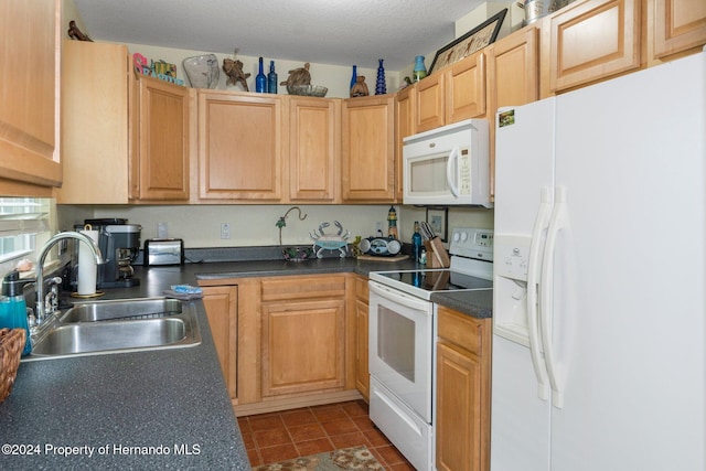 kitchen featuring a textured ceiling, sink, and white appliances