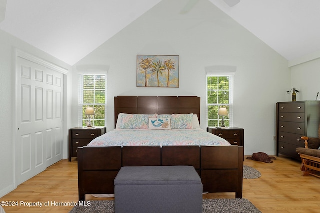7413 Gettysburg Dr, Weeki Wachee, FL 34607 - bedroom featuring light wood-type flooring, multiple windows, and high vaulted ceiling