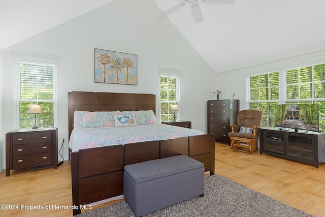 7413 Gettysburg Dr, Weeki Wachee, FL 34607 - bedroom with high vaulted ceiling, light wood-style flooring, and a ceiling fan