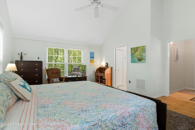 7413 Gettysburg Dr, Weeki Wachee, FL 34607 - bedroom with high vaulted ceiling, wood finished floors, baseboards, and a ceiling fan