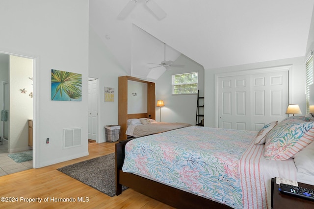 bedroom featuring connected bathroom, ceiling fan, hardwood / wood-style flooring, and high vaulted ceiling