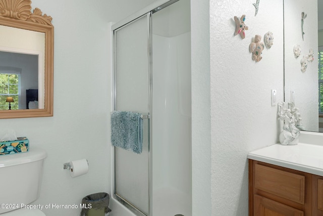 7413 Gettysburg Dr, Weeki Wachee, FL 34607 - bathroom featuring a shower stall, vanity, and toilet