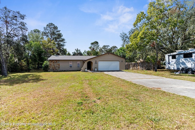 ranch-style house featuring a garage and a front yard