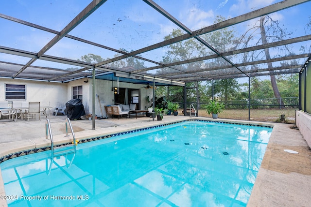 view of swimming pool featuring a patio area, a grill, glass enclosure, and an outdoor hangout area