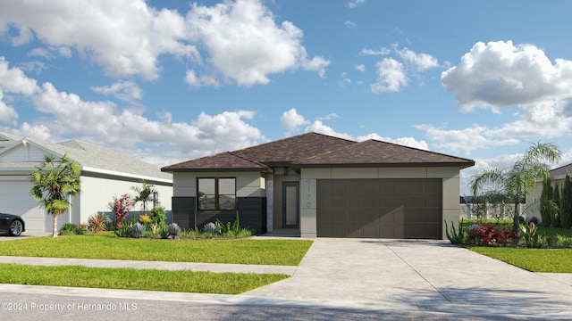 view of front of home with a front lawn and a garage