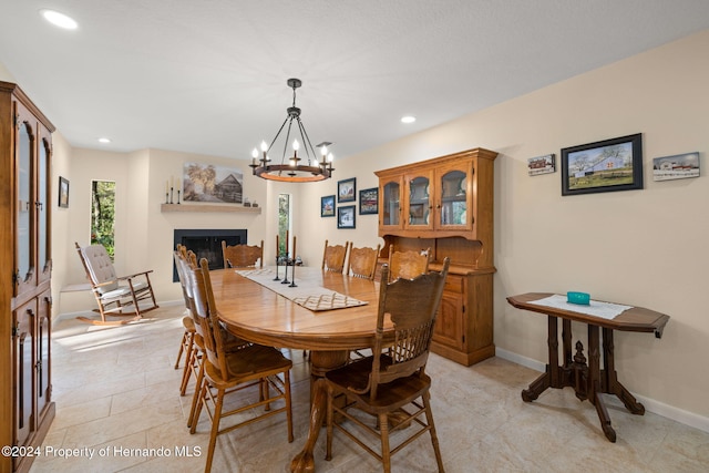 dining room with light tile patterned floors and a notable chandelier