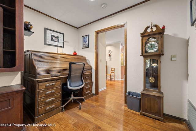 office with light hardwood / wood-style floors and crown molding