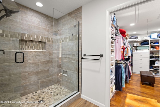 bathroom with wood-type flooring and walk in shower