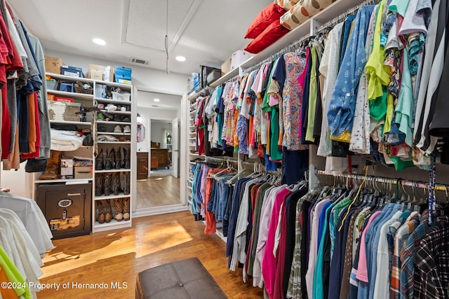 walk in closet with hardwood / wood-style floors