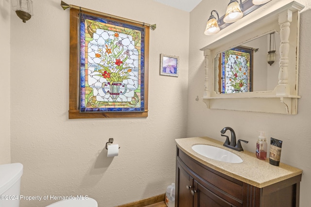 bathroom with vanity and toilet