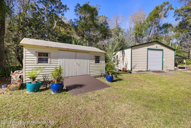 view of outbuilding with a garage and a yard