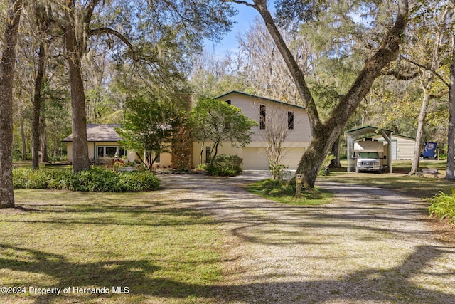 view of front of house featuring a front lawn and a carport