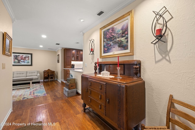 hallway featuring dark hardwood / wood-style floors and ornamental molding